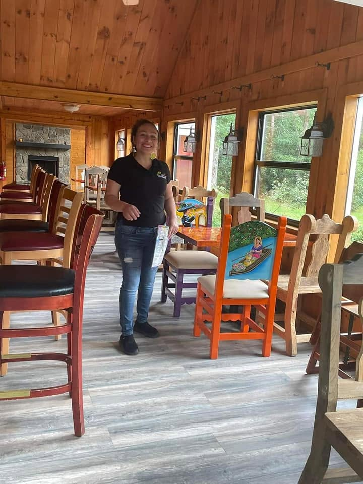 A warm welcome inside Las Margaritas, with colorful Mexican chairs and a wood-paneled dining room